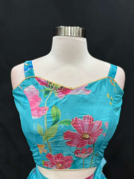 Turn heads with this stunning customized organza lehenga set. The vibrant turquoise blue lehenga with floral detailing pairs beautifully with a hot pink embroidered dupatta. Perfect for festive occasions, weddings. Available in size 34/36/38.