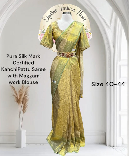 Pure Kanchi Pattu Silk mark certified Saree in shimmering gold with a subtle green border. Paired with an exquisite handcrafted Maggam work blouse. Available in size 40 to 44.