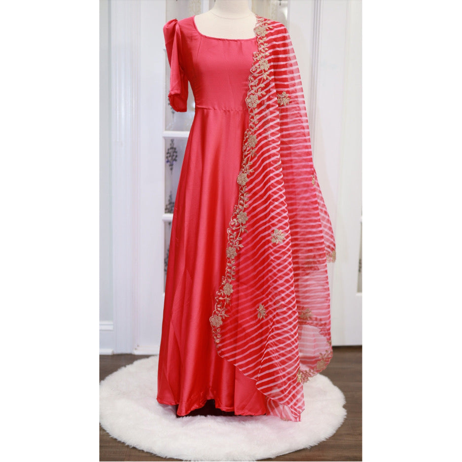 Beautiful peach red color satin long gown with organza Dupatta. The gown has lining and comes with tassels.Size:40, 44 length: 55 inches