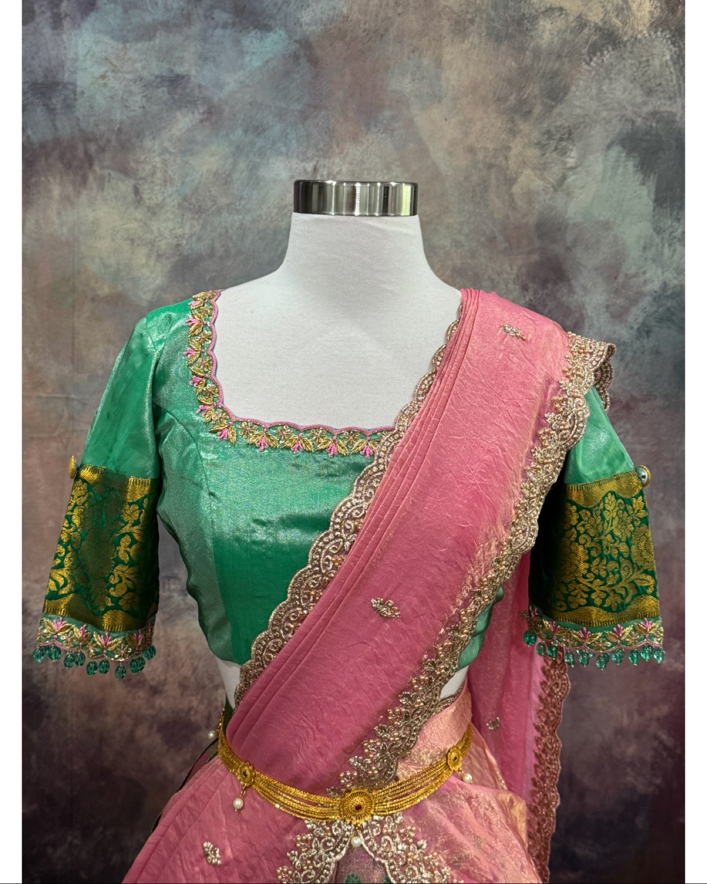 Kanchi Pattu half saree in shades of pinkgreen. Paired with a rich Maggam work designer blouse size is 36 to 40 its perfect for festive vie