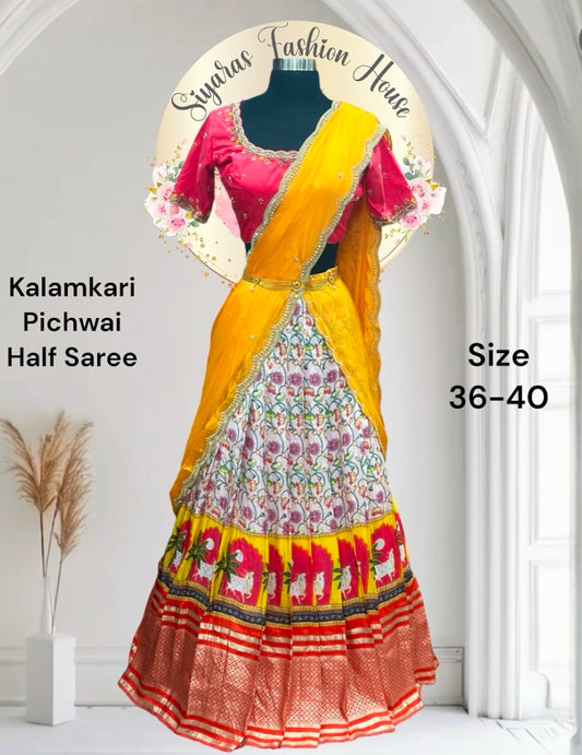 customized traditional Silk Kalamkari half saree adorned with a vibrant pichwai design. Paired with an elegant Maggam work blouse