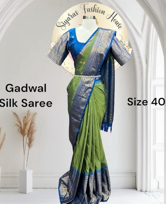 Royal vibes only!
This green & blue Gadwal silk saree is stealing the show with its rich pattu border and Maggam work blouse. Size 40-44.