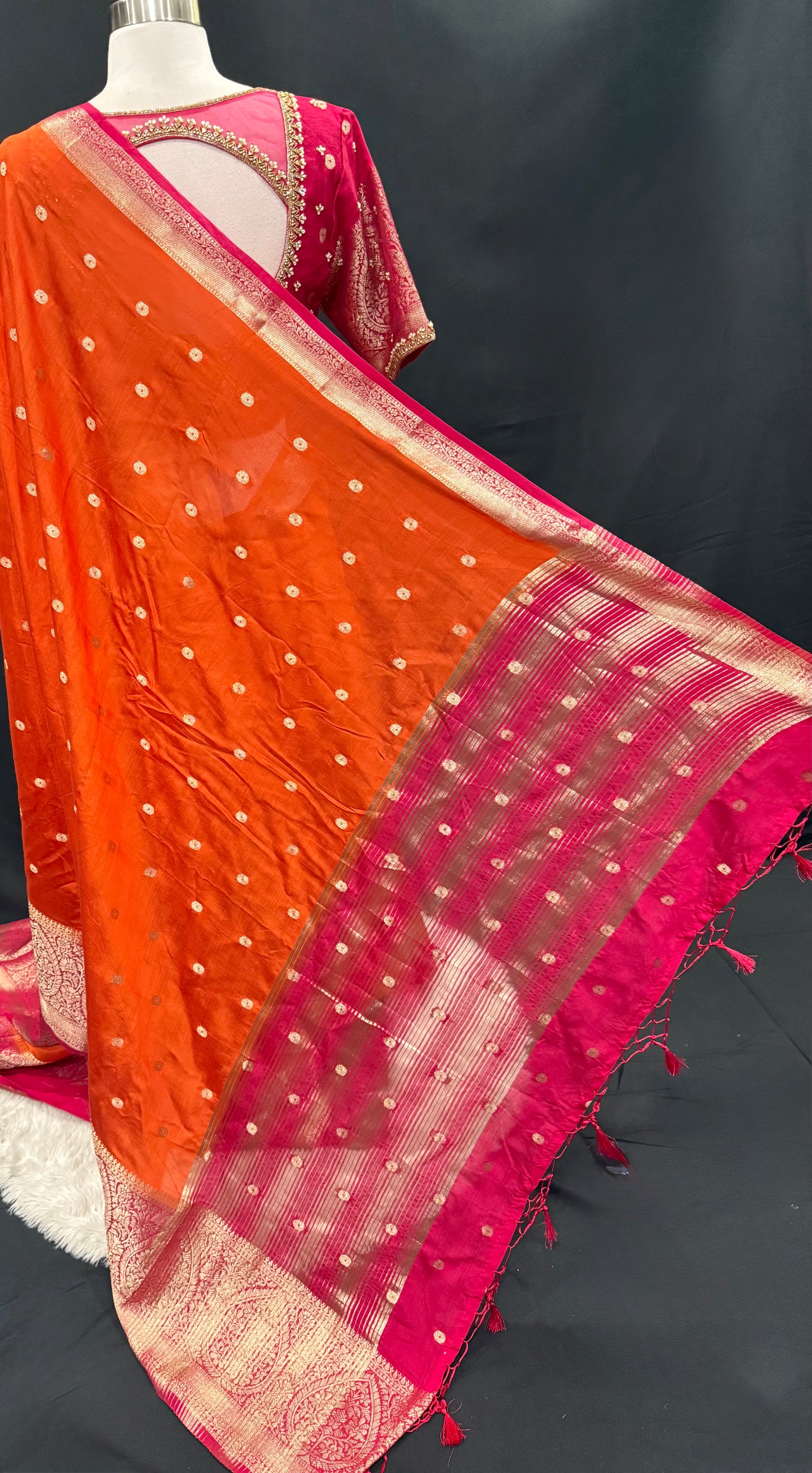 Stunning orange and pink combo Raw Mango silk saree paired with a contrasting pink blouse and Hand work on the blouse. Available in size 38 upto 42. Can be altered to your size.