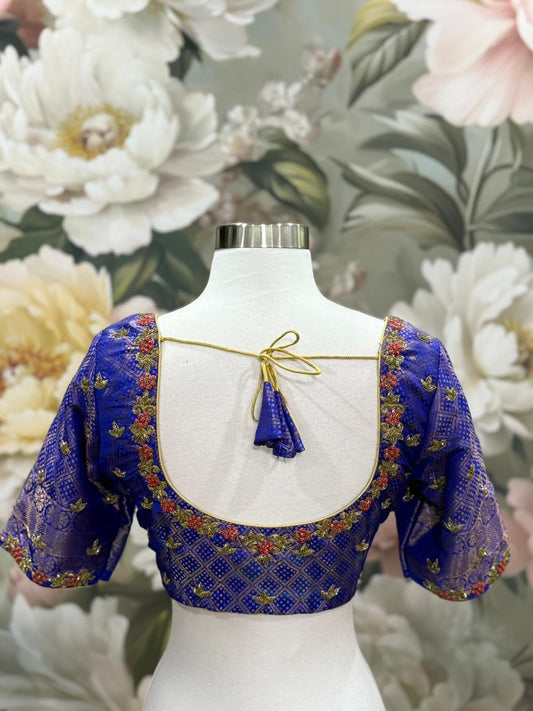 This stunning Soft Silk Saree paired with a royal Maggam work blouse. The rich hues of red and blue blend beautifully, making it perfect for weddings, festive vibes. Available in size 40 - 42.