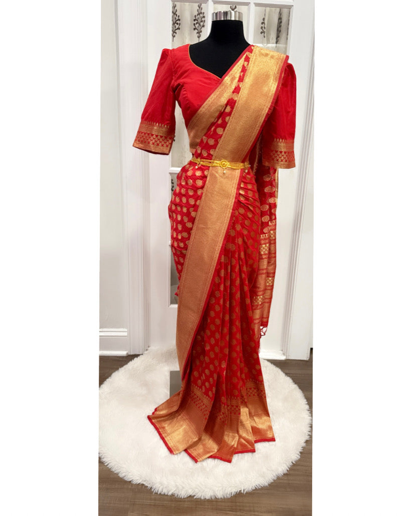Fiery Red silk saree with elaborate zari work and comes with stitched Designer Blouse