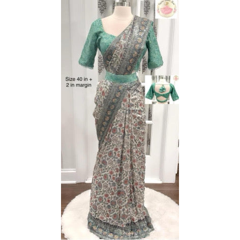 Dazzling partywear heavy sequin saree in silver grey and light green mint hues. Comes with a stitched blouse size 40 with bead embellishments