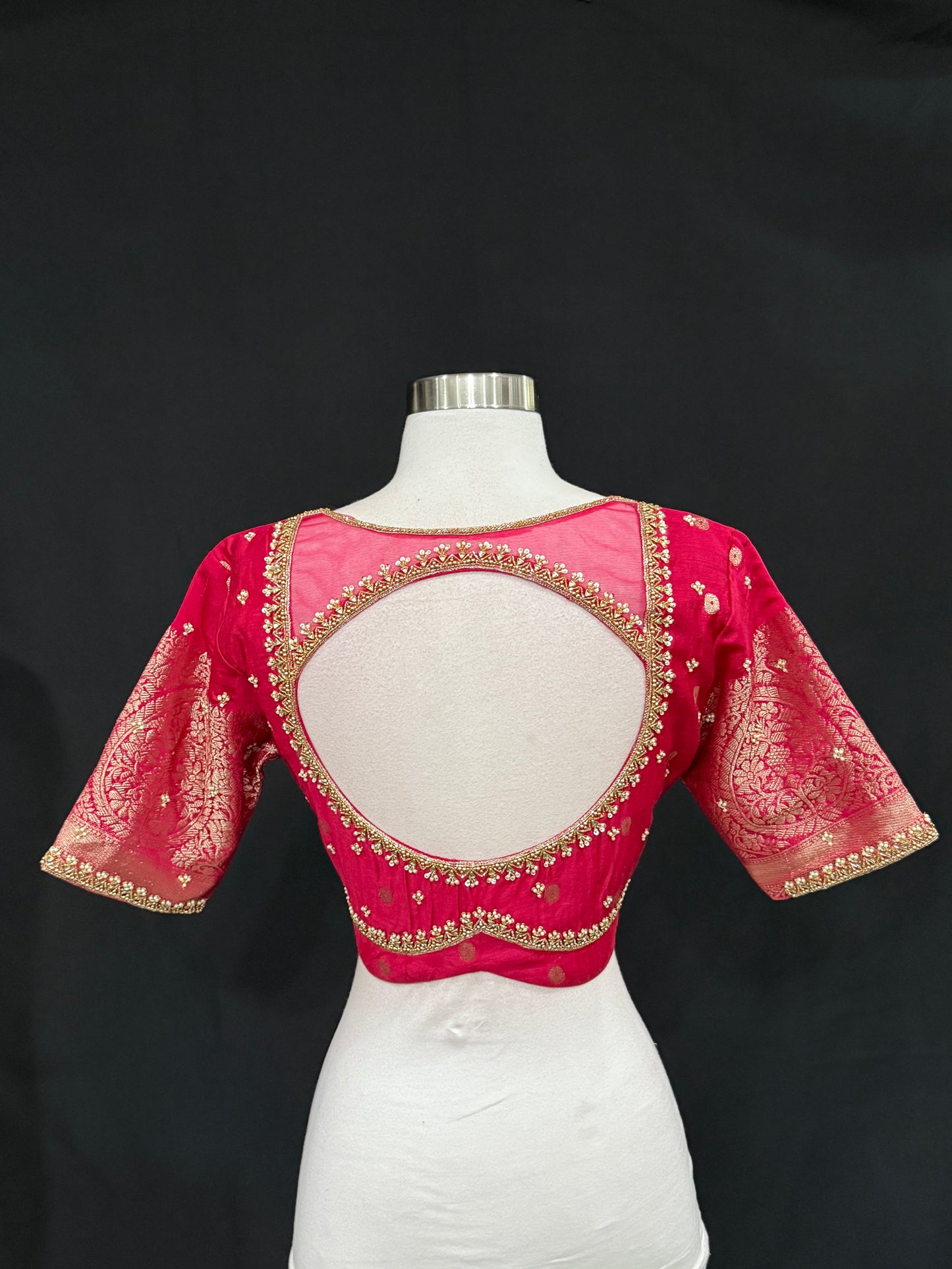 Stunning orange and pink combo Raw Mango silk saree paired with a contrasting pink blouse and Hand work on the blouse. Available in size 38 upto 42. Can be altered to your size.