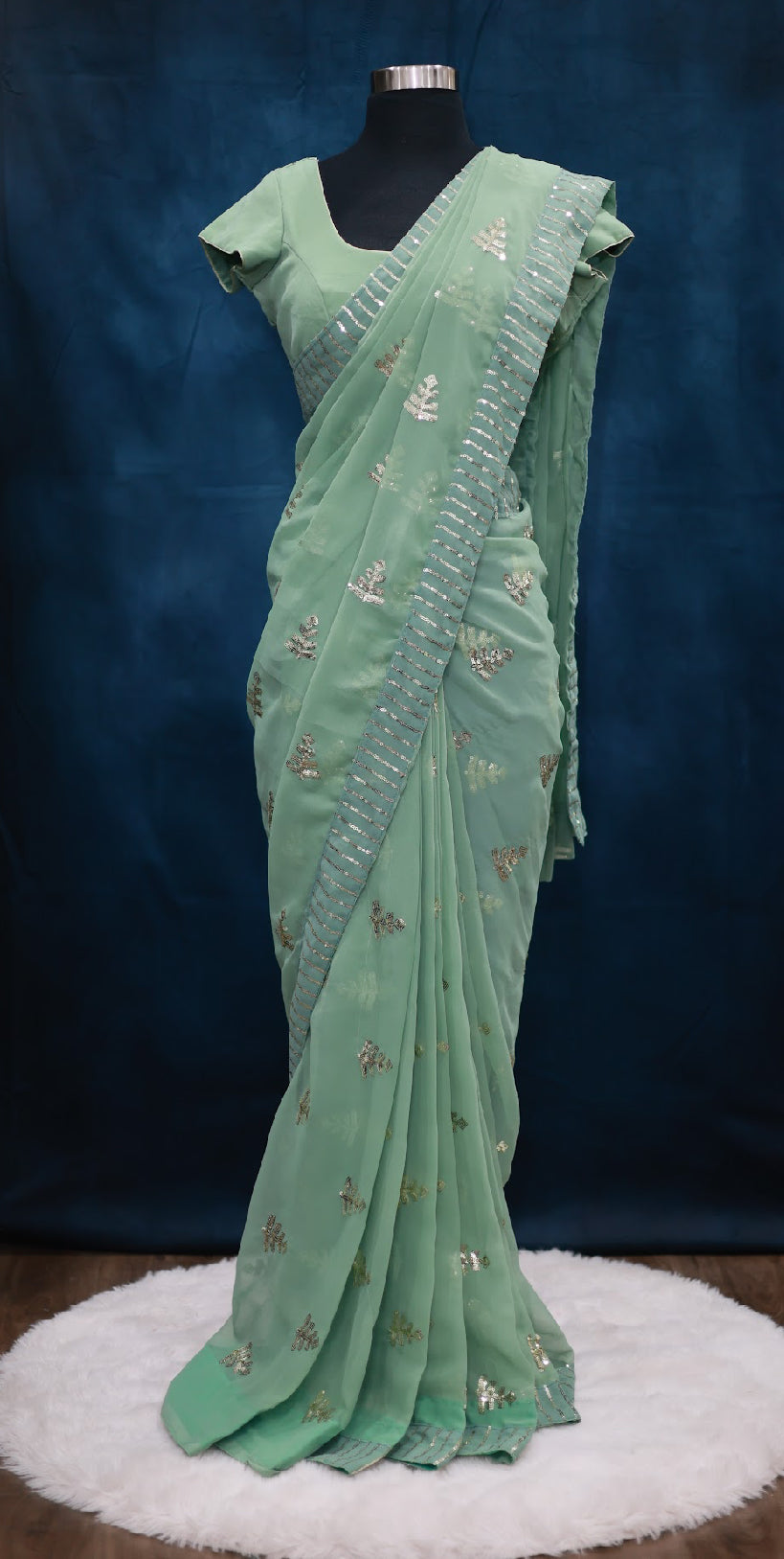 Beautiful georgette saree with sequin all over comes with stitched blouse. Available in size 36