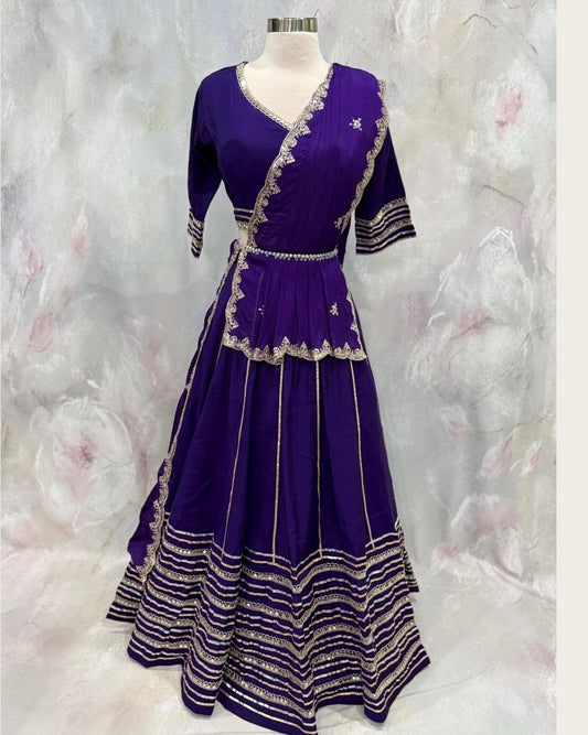 Beautiful purple ensemble with stunning border details. Gorgeous embellished dupatta with the blouse. Available in size 38 to 40