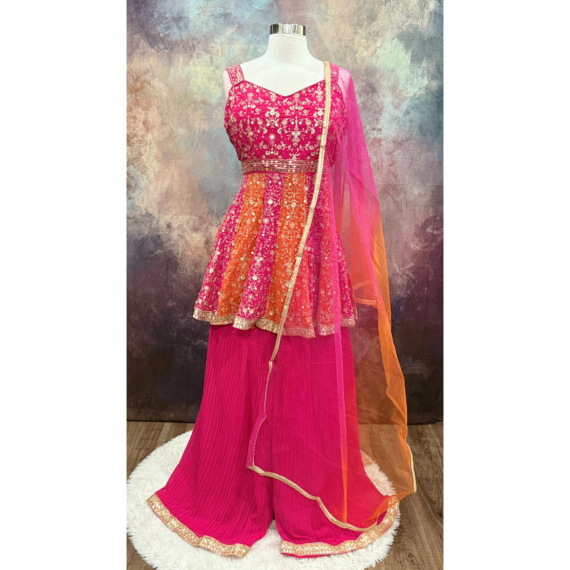 Stunning Partywear Peplum Sharara Set in vibrant shades of pink and orange comes with exquisite embroidery work. Perfect for weddings, sangeet, or festival. Size is  XL 42
