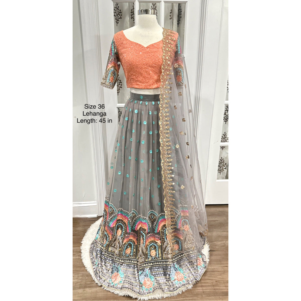 Stunning partywear net lehenga in vibrant peach and gray hues! Perfect for festive occasions