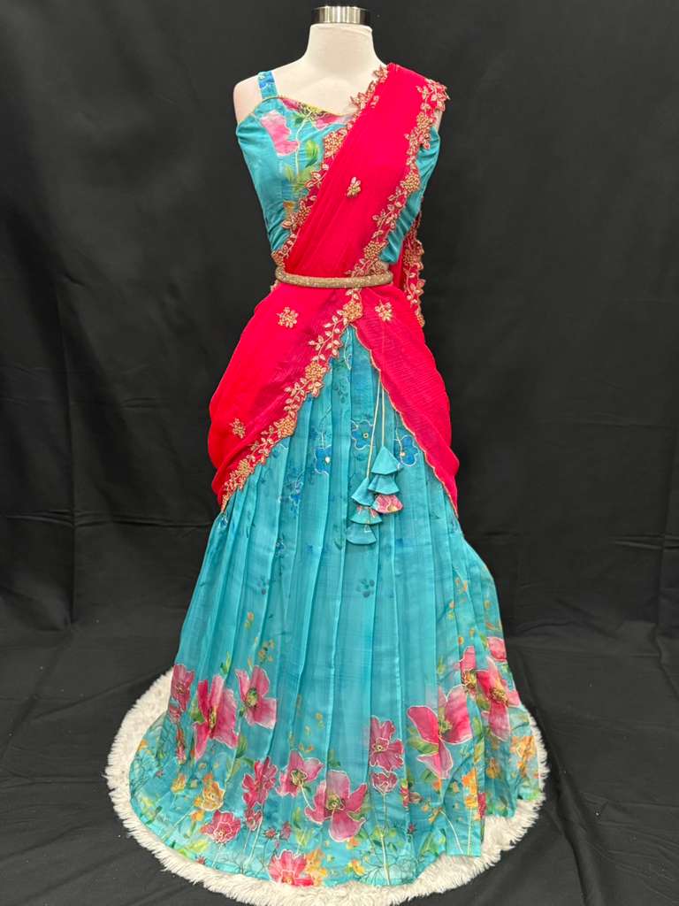 Turn heads with this stunning customized organza lehenga set. The vibrant turquoise blue lehenga with floral detailing pairs beautifully with a hot pink embroidered dupatta. Perfect for festive occasions, weddings. Available in size 34/36/38.