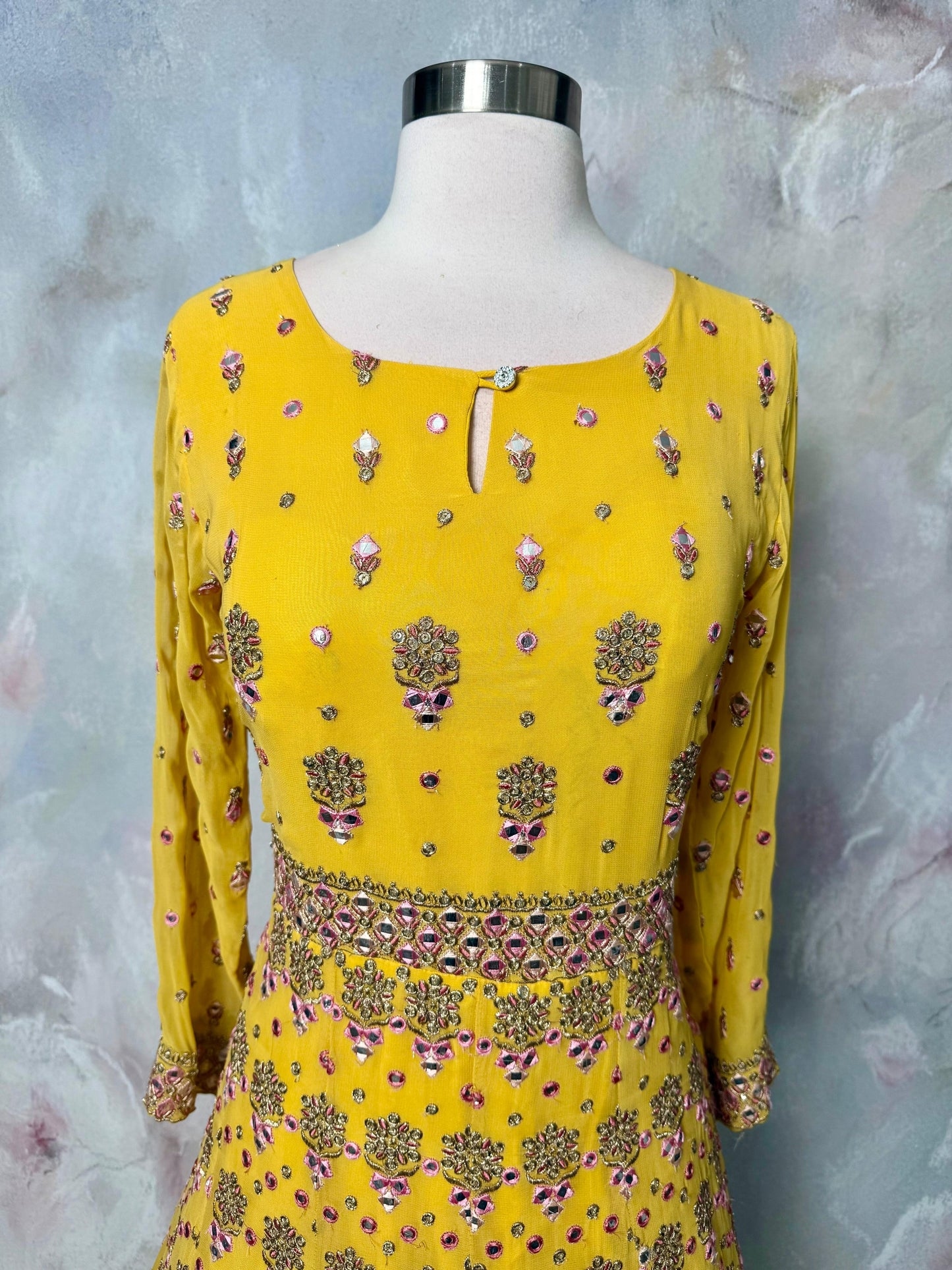 Soft hues, regal charm and magic in yellow. Available in Size 42. Step into royal vibes with this gorgeous georgette long gown & dupatta.