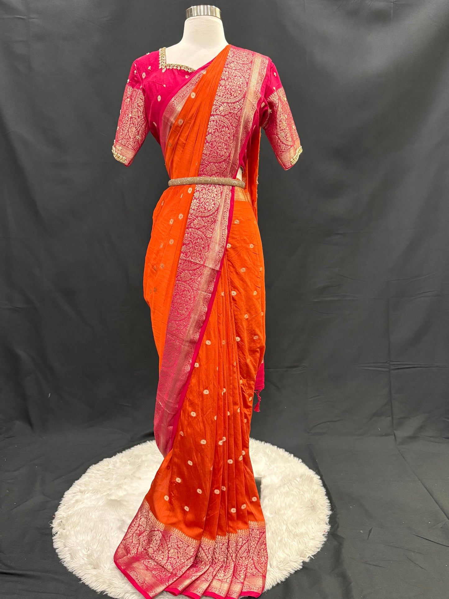 Stunning orange and pink combo Raw Mango silk saree paired with a contrasting pink blouse and Hand work on the blouse. Available in size 38 upto 42. Can be altered to your size.