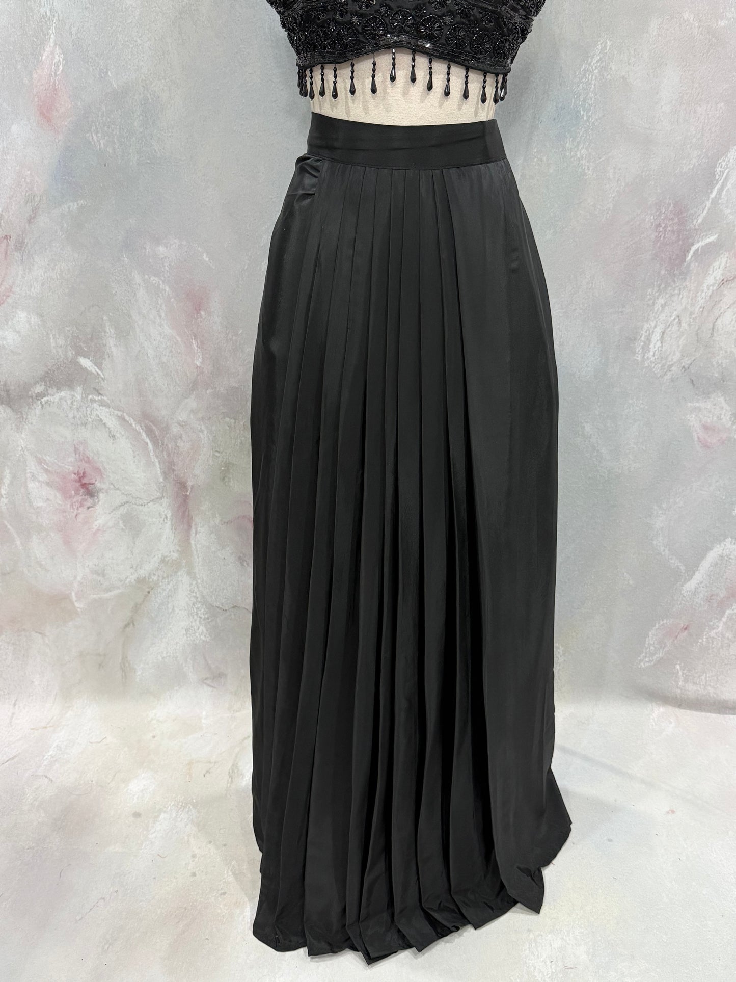 Black Crop Top Lehenga with an Elegant Jacket.Featuring intricate handwork on the crop top, a graceful flowing lehenga, and a chic long jacket that adds a touch of royal sophistication