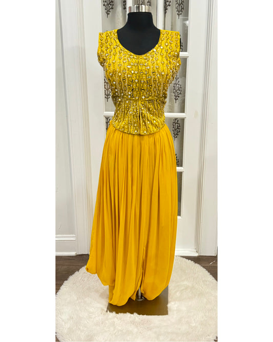 Perfect yellow Haldi outfit with hand work on peplum top with dhoti style skirt. Available in size 36 and 38.