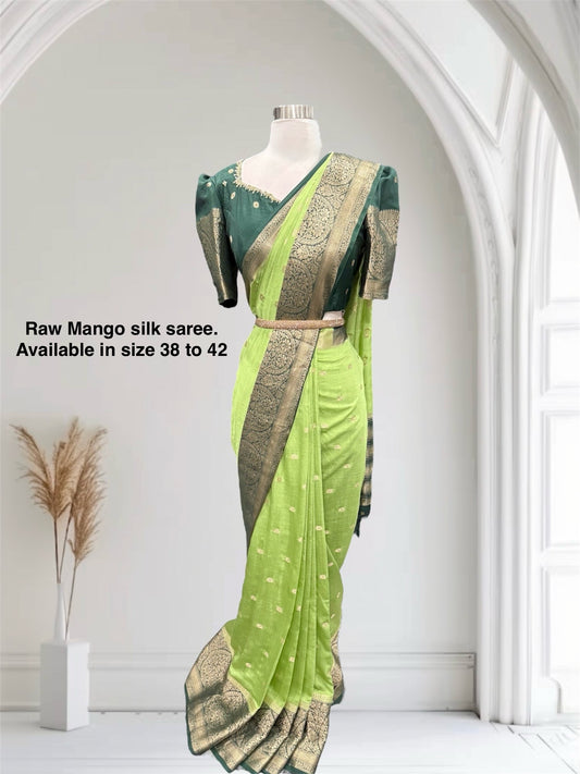 Stunning Green combo Raw Mango silk saree paired with a contrasting pink blouse and Hand work on the blouse. Size 38 upto 42.