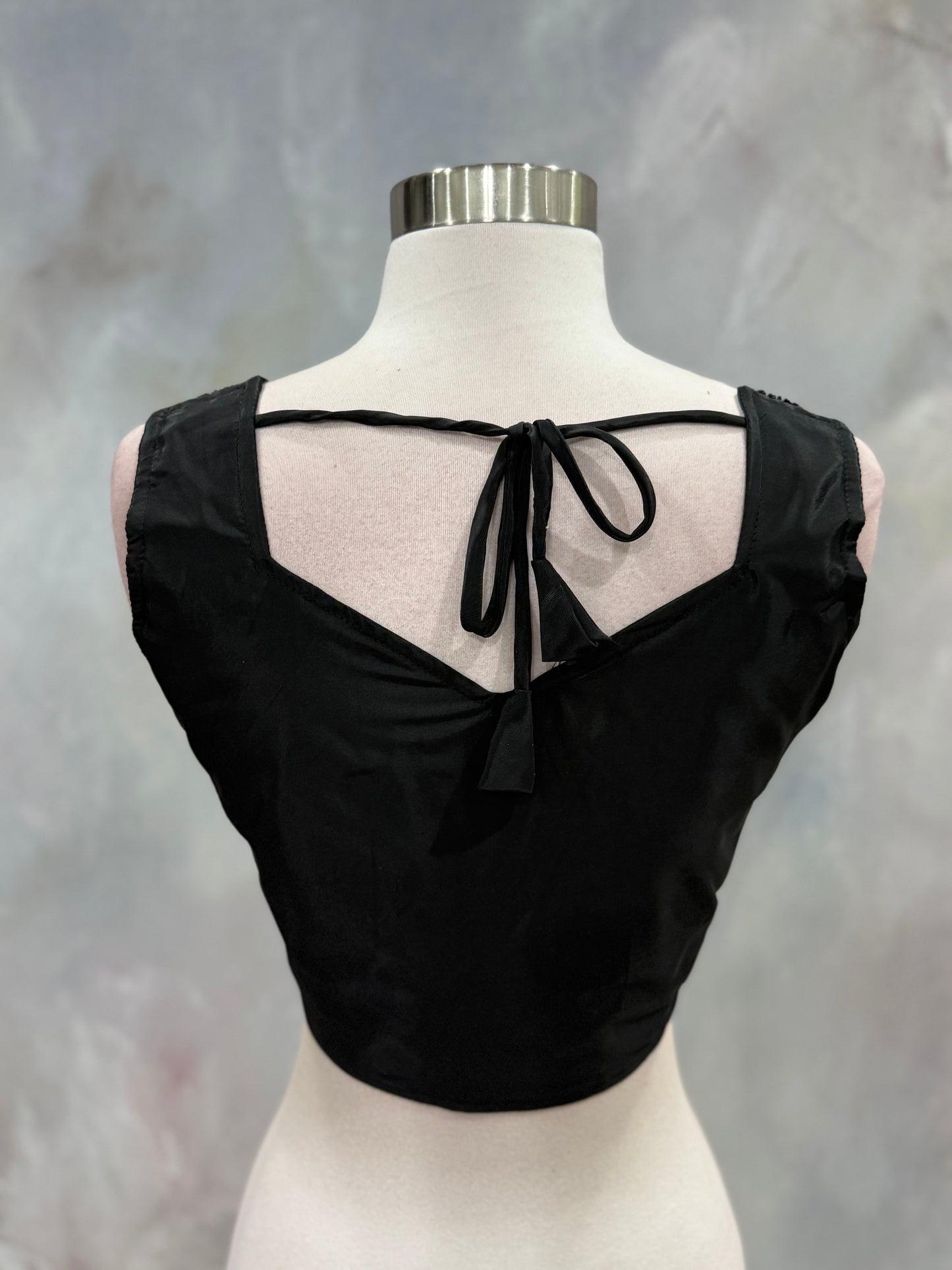 Black Crop Top Lehenga with an Elegant Jacket.Featuring intricate handwork on the crop top, a graceful flowing lehenga, and a chic long jacket that adds a touch of royal sophistication