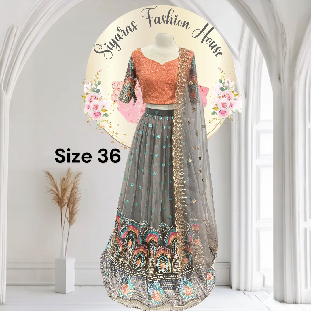 Stunning partywear net lehenga in vibrant peach and gray hues! Perfect for festive occasions