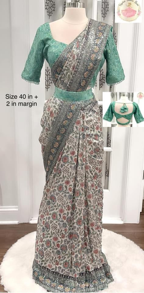 Dazzling partywear heavy sequin saree in silver grey and light green mint hues. Comes with a stitched blouse size 40 with bead embellishments