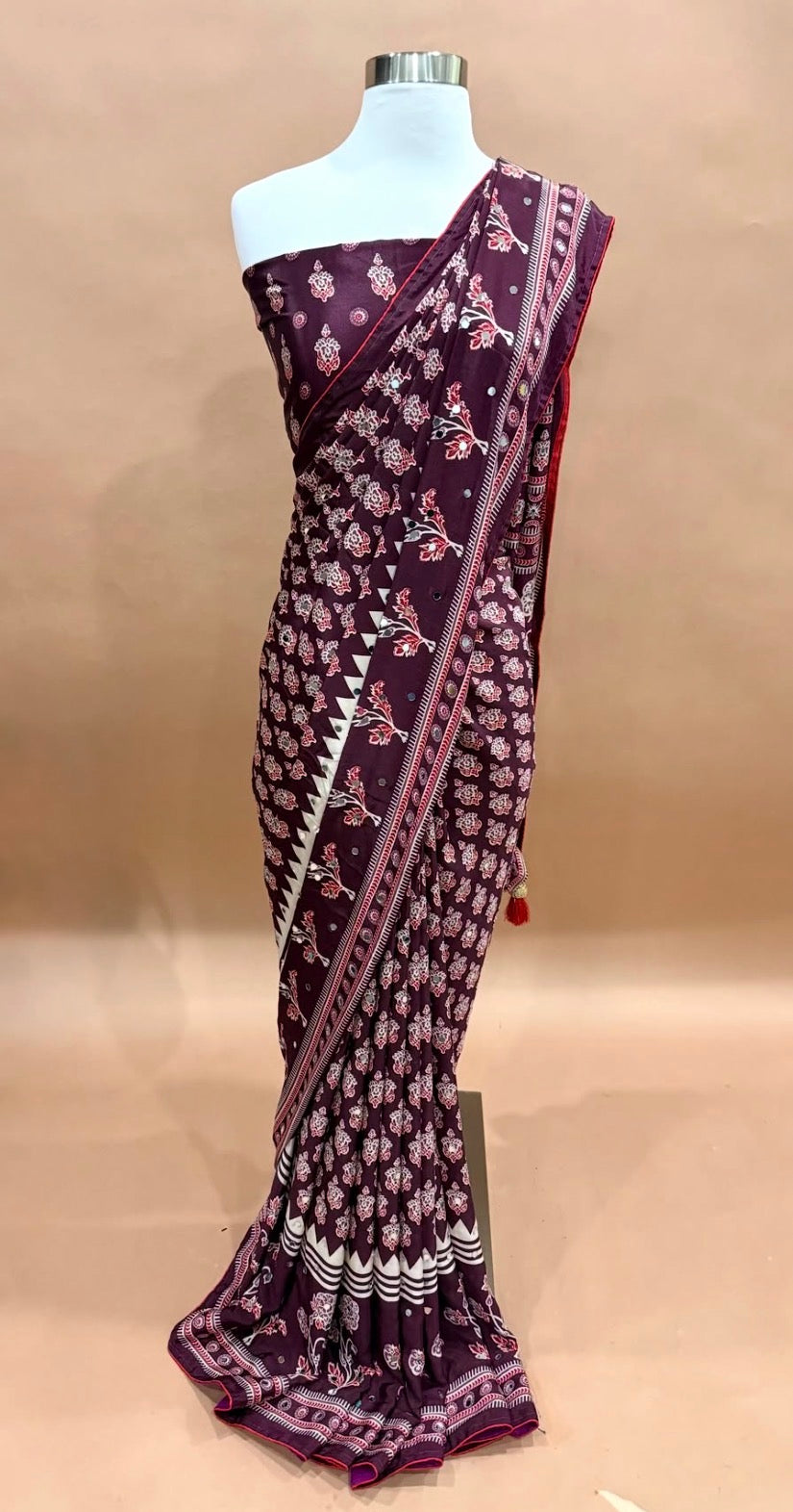 Gorgeous Ajrakh Silk Sarees with Mirror  Wine Maroon – Royal, graceful & sophisticated, adorned intricate cream and red patterns.✨ Beautiful mirror work🌸 Traditional Ajrakh-inspired prints💃 Elegant borders & stunning drapes